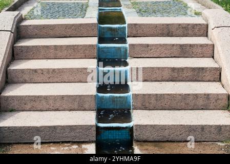 water flowing between granite steps in garden Stock Photo