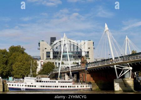 Hungerford & Golden Jubilee Bridges looking towards Charing Cross Station and Embankment Place, London, England. Stock Photo