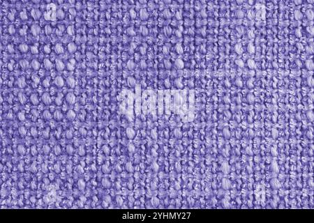 Texture of purple jacquard fabric of rough weave, cloth structure background, close up, macro. Material for home textile, upholstery and curtain decor Stock Photo