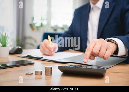 Business man using calculator in office. Business accounting concept Stock Photo