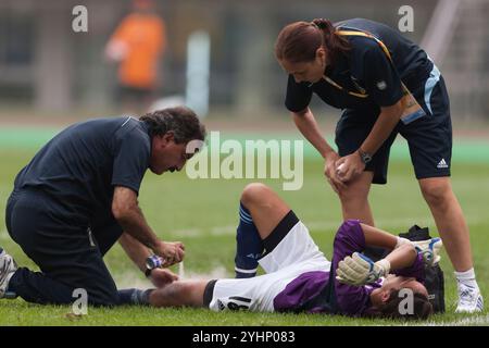 TIANJIN, CHINA - AUGUST 6:  Injured goalkeeper Vanina Correa receives treatment on her knee after being shaken up during a Group E match against Canada at the Beijing Olympic Games women's soccer tournament August 6, 2008 at Tianjin Olympic Sports Center Stadium in Tianjin, China.  (Photograph by Jonathan P. Larsen / Diadem Images) Stock Photo