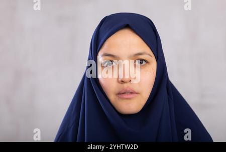 Portrait of young serious woman in hijab posing in studio Stock Photo