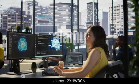 Admin developing artificial intelligence machine learning APIs solving complex problems. Woman training AI predictive models capable of handling resource intensive tasks, camera B Stock Photo