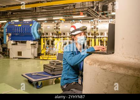 Survey engineer Laure Wilhelm working at the East Area Renovation Project at CERN (European Organization for Nuclear Research). She is responsible for installing reference points to establish the survey network for the area. Based on this network and in accordance with the directives from the beamline physicists, she aligns all new beamline equipment for the East Area. Stock Photo