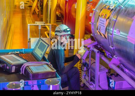 Mechanical engineer Natalia Magdalena Koziol working on the ATLAS (A Toroidal LHC Apparatus) experiment at CERN (European Organization for Nuclear Research). ATLAS is one of two general-purpose detectors at the Large Hadron Collider (LHC). It investigates a wide range of physics, from the search for the Higgs boson to extra dimensions and particles that could make up dark matter. Koziol is responsible for quality assurance of the insulation vacuum system during the Long Shutdown 2. Stock Photo