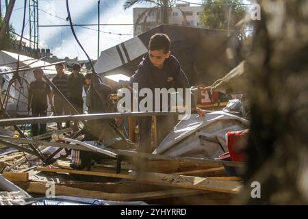 Gaza City, Palestine. 12th Nov, 2024. Palestinians inspect the damage following Israeli bombardment which hit a camp for displaced people from other parts of northern Gaza inside the Al-Jazira Sports Club in Gaza City. Credit: SOPA Images Limited/Alamy Live News Stock Photo