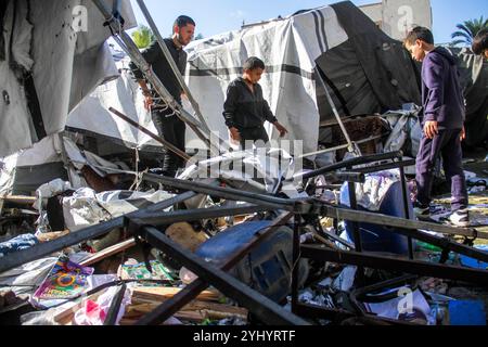 Gaza City, Palestine. 12th Nov, 2024. Palestinians inspect the damage following Israeli bombardment which hit a camp for displaced people from other parts of northern Gaza inside the Al-Jazira Sports Club in Gaza City. Credit: SOPA Images Limited/Alamy Live News Stock Photo