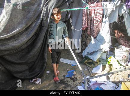 Gaza City, Palestine. 12th Nov, 2024. Palestinians inspect the damage following Israeli bombardment which hit a camp for displaced people from other parts of northern Gaza inside the Al-Jazira Sports Club in Gaza City. (Photo by Mahmoud Issa/SOPA Images/Sipa USA) Credit: Sipa USA/Alamy Live News Stock Photo