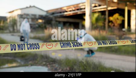 Forensic, people and crime scene for evidence outdoor, dna investigation and murder inspection. Team, hazmat and equipment with photograph review, csi Stock Photo