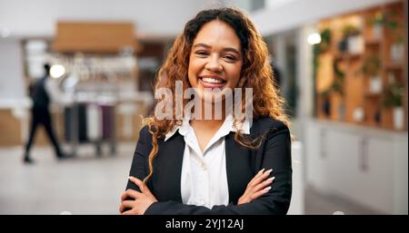 Woman, portrait and arms crossed of manager in hotel, customer service and friendly concierge. Female person, lobby reception and proud assistance in Stock Photo