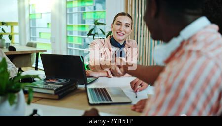 Campus, collaboration and students with handshake for education, english project and studying success. College, friends and woman with shaking hands Stock Photo