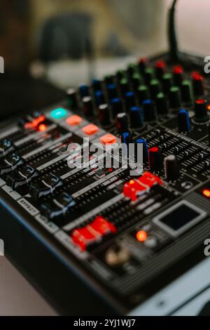 audio mixer soundboard with various knobs, sliders, and indicator lights. Perfect for showcasing professional audio equipment, music production, and l Stock Photo
