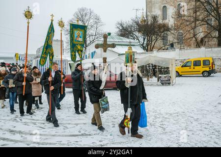 Ukraine, city of Romny, January 19, 2013: Procession of the Holy Cross to the baptismal font on the feast of the Baptism of the Lord. Epiphany. Feast Stock Photo