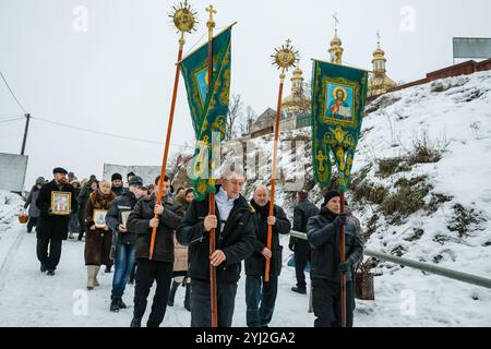 Ukraine, city of Romny, January 19, 2013: Procession of the Holy Cross to the baptismal font on the feast of the Baptism of the Lord. Epiphany. Feast Stock Photo