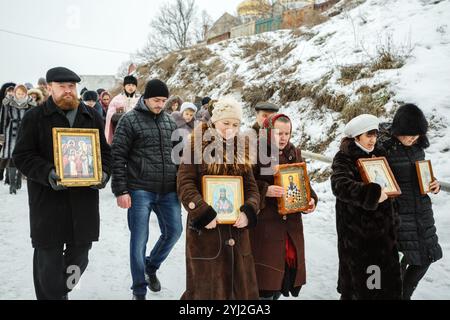 Ukraine, city of Romny, January 19, 2013: Procession of the Holy Cross to the baptismal font on the feast of the Baptism of the Lord. Epiphany. Feast Stock Photo