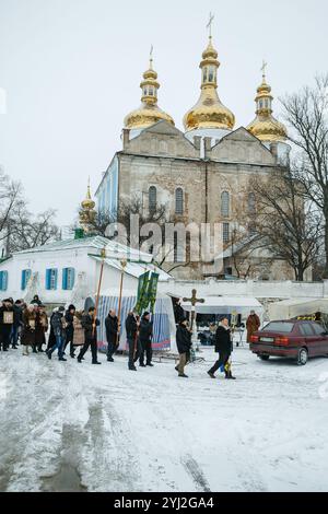 Ukraine, city of Romny, January 19, 2013: Procession of the Holy Cross to the baptismal font on the feast of the Baptism of the Lord. Epiphany. Feast Stock Photo