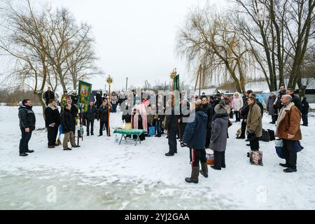 Ukraine, city of Romny, January 19, 2013: Procession of the Holy Cross to the baptismal font on the feast of the Baptism of the Lord. Epiphany. Feast Stock Photo