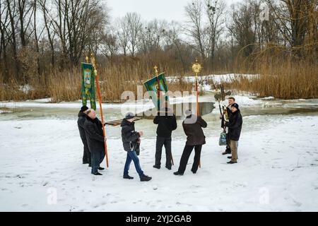 Ukraine, city of Romny, January 19, 2013: Procession of the Holy Cross to the baptismal font on the feast of the Baptism of the Lord. Epiphany. Feast Stock Photo