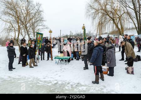 Ukraine, city of Romny, January 19, 2013: Procession of the Holy Cross to the baptismal font on the feast of the Baptism of the Lord. Epiphany. Feast Stock Photo