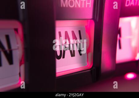 January 1st on flip calendar clock in pink light Stock Photo