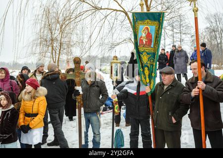 Ukraine, city of Romny, January 19, 2013: Procession of the Holy Cross to the baptismal font on the feast of the Baptism of the Lord. Epiphany. Feast Stock Photo