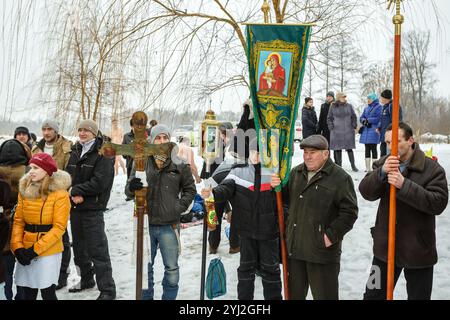 Ukraine, city of Romny, January 19, 2013: Procession of the Holy Cross to the baptismal font on the feast of the Baptism of the Lord. Epiphany. Feast Stock Photo