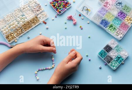 Craft workspace with colorful threads, beads, scissors, and organized ...