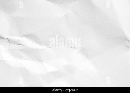 Crumpled white paper with subtle wrinkles creating a textured abstract background for use in minimalist posters and web banners with a raw aesthetic Stock Photo