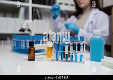 Modern Scientific Laboratory with Test Tubes and Researcher Conducting Experiments in a Controlled Environment Stock Photo