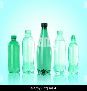 Different plastic bottles with water on turquoise background Stock Photo
