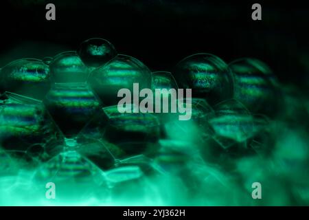 Green liquid phenomenal structure, green oils on a dark background, colourful abstract, surrealistic art, line of light, chaos of reflection Stock Photo