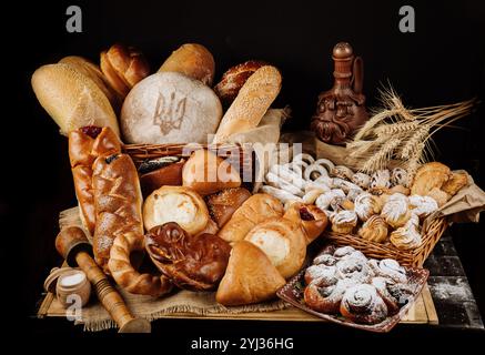 Assortment of traditional bread and pastries with Ukrainian symbols on a rustic background Stock Photo