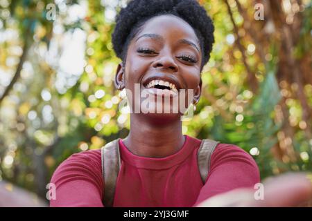 Bright and Cheerful Portrait of a Smiling Woman Outdoors in Nature with Sunlight Stock Photo