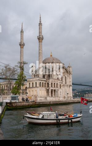 Boat and Ortakoy Mosque in Istanbul, Turkey Stock Photo