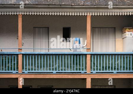 Mounaque of Campan, Tall Doll or Puppet on Wooden Veranda, Verandah or Balcony of a Traditional Village House, Campan Hautes-Pyrénées Pyrenees France Stock Photo