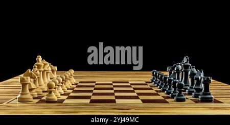 Wooden chess pieces standing on chessboard black background Stock Photo