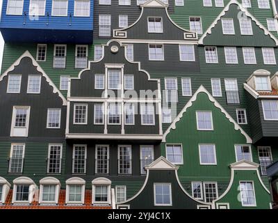 Detail of modern green hotel building as with many stacked small traditional buildings of Inntel Hotels Amsterdam Zaandam in a modern part of the city Stock Photo