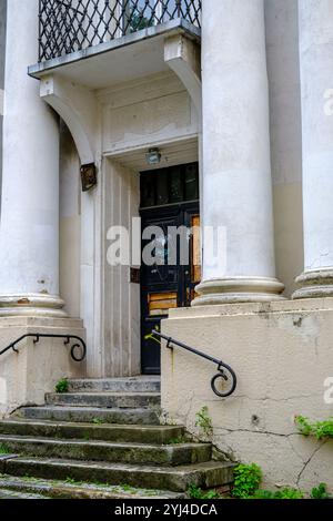 Property-damaged front door of a dilapidated historic building in the old town centre of Opole, Opole Voivodeship, Poland. Stock Photo