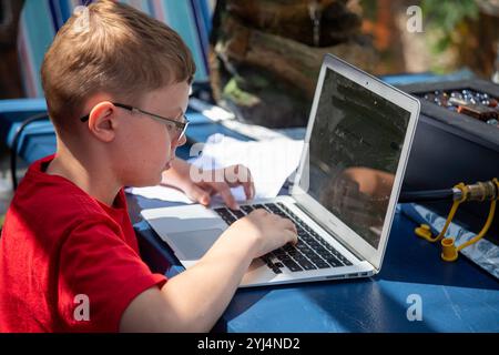 Denver, Colorado - Ten-year-old Adam Hjermstad Jr. works on a laptop computer. Stock Photo