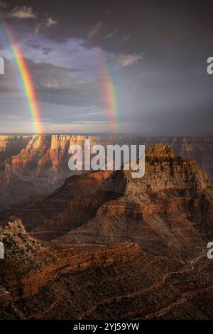 Evening summer monsoon showers and sunbreaks create this double rainbow over Vishnu Temple from the North Rim at Cape Royal in Arizona's Grand Canyon Stock Photo