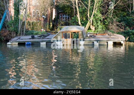 Traditional Broads cruiser sunk at her moorings in Thorpe on the outskirts of Norwich on the River Yare, Broads National Park Stock Photo