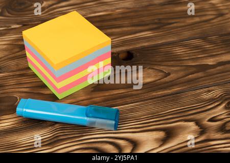 A stack of colorful notes, reminder stickers and a blue marker on a wooden table. organization, planning Stock Photo