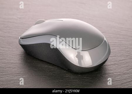 One wireless computer mouse on slate stone, macro. Stock Photo