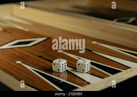 Backgammon game with dices on wooden board. Stock Photo