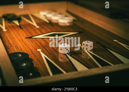 Backgammon game with dices on wooden board. Stock Photo