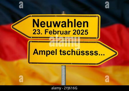 Neuwahlen am 23. Februar 2025 und Ampel tschüssss... Zwei Wegweiser über einer Deutschland-Fahne zeigen in gegensätzlicher Richtung und sind beschrift Stock Photo