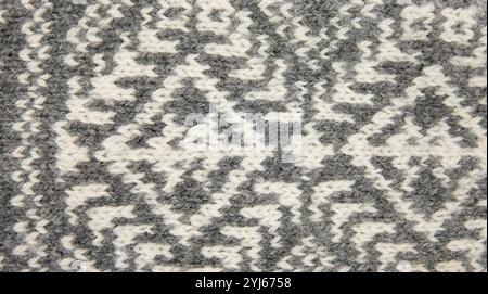 Above view of gray and white traditional knitted pattern. Background texture concept. Stock Photo