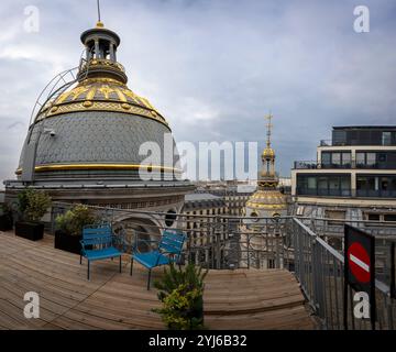 Paris, France - 11 13 2024: Boulevard Haussmann. View of Paris and golden dome from the roof of Le Printemps at christmas Stock Photo