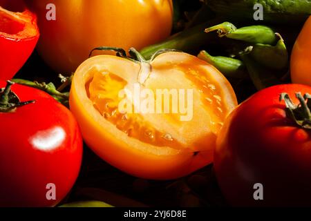 sliced yellow tomato on black background Stock Photo