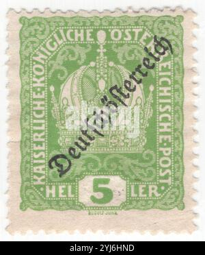 AUSTRIA - 1918 December: 5 heller light green postage stamp depicting Imperial Crown of Austria, which was previously used by the monarchs of the Habsburg monarchy. It consists of a circlet, a high arch and a mitre. Austrian Crown overprinted diagonally "Deutschosterreich". The crown was made in 1602 by Jan Vermeyen as the personal crown of Holy Roman Emperor Rudolf II, and also known as the Crown of Emperor Rudolf II. In 1804 it became the official crown of the newly constituted Austrian Empire. After 1867 it remained the imperial crown of the Cisleithania Stock Photo